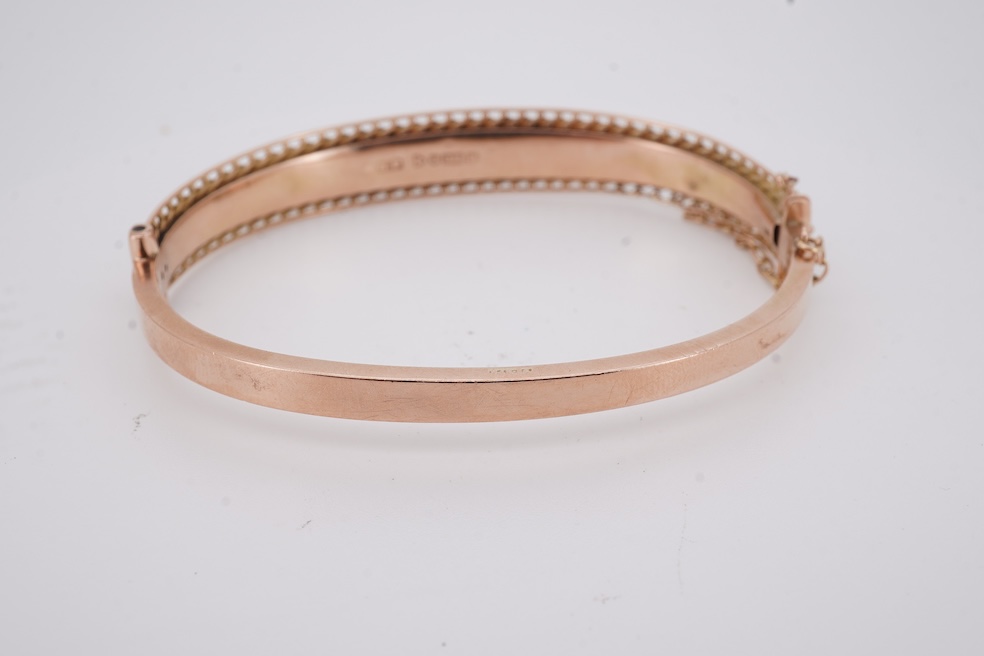 An Edwardian 9ct gold, sapphire and diamond set hinged bangle, Chester, 1909, interior diameter 57mm, gross weight 10 grams. Condition - poor